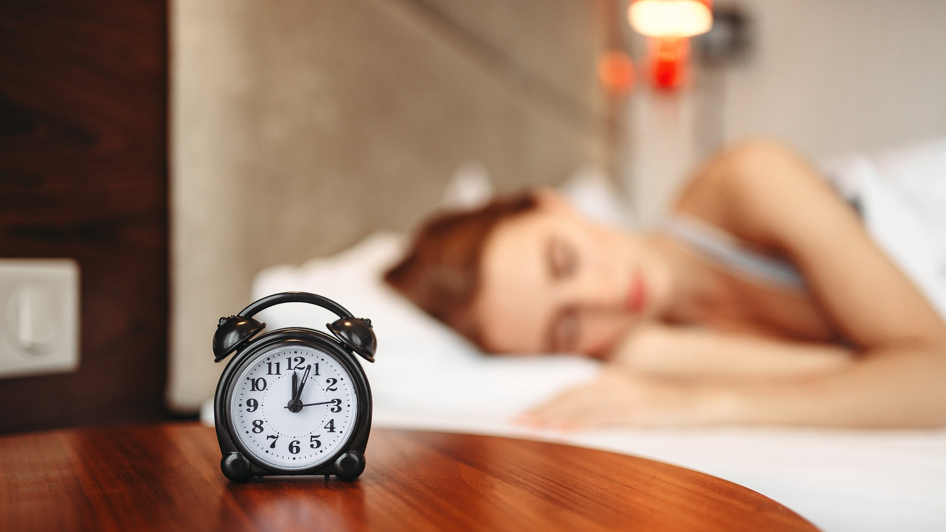 Sleeping Woman with Alarm Clock in the Forefront